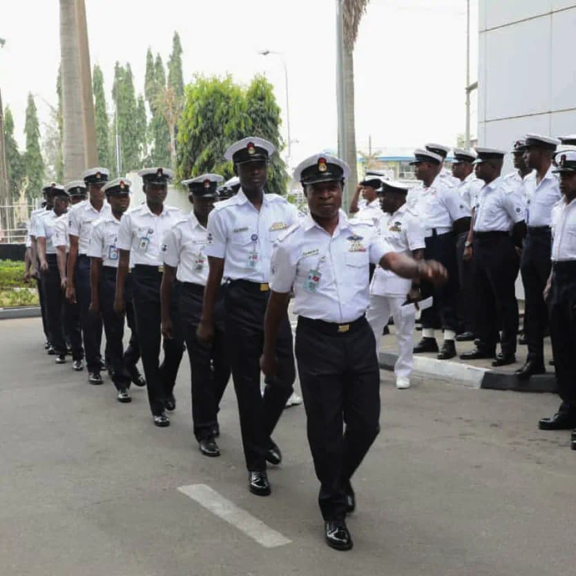 Officers marching in white ceremonial uniform